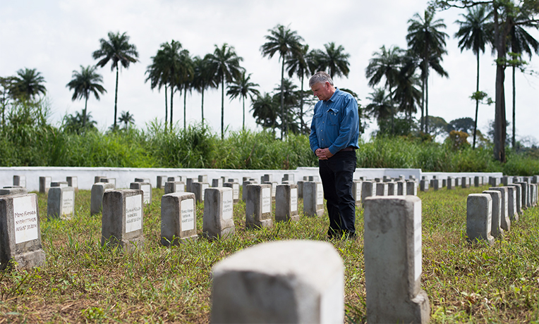 Franklin Graham pauses to pray at Ebola Memorial Cemetery in Foya, Liberia.