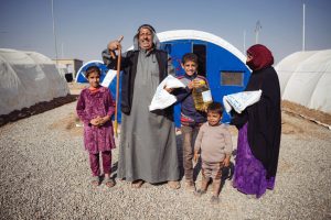 62-YEAR-OLD ABDUL RAHMAN* WITH SOME OF HIS FAMILY. THEY RECEIVED THE MONTHLY FOOD RATION NOV. 7. HE ALLOWED SAMARITAN’S PURSE TO PRAY FOR HIM AND HIS ILLNESSES.