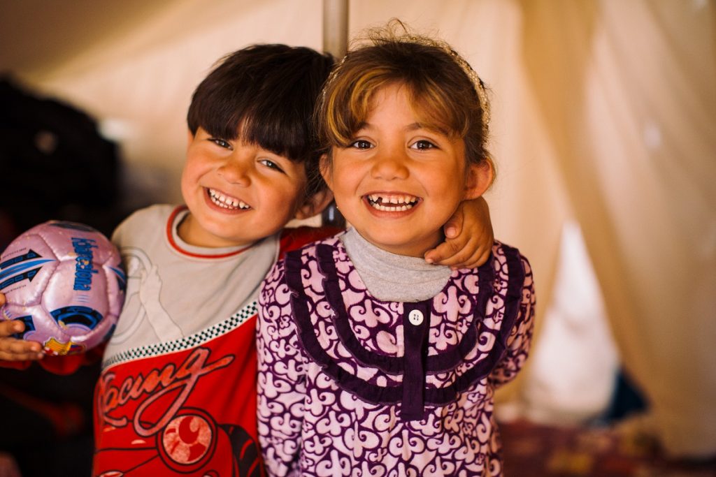 Ala's older two children play together in the family's makeshift home.