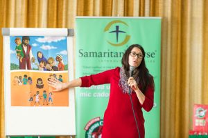Local partner sharing about Jesus at outreach event