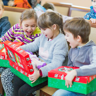 Group of children looking at shoebox gifts in Moldova