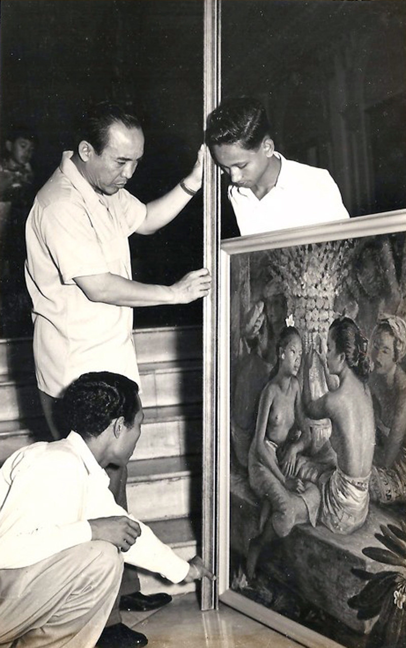 Sukarno, Dullah (crouched), and Gapoer examining a painting at Merdeka Palace, 1950s.