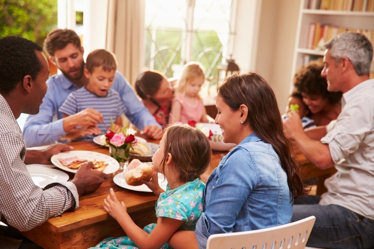 A group of people sitting at a table Description generated with very high confidence