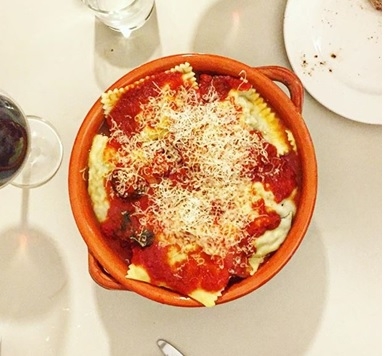 A bowl of food on a plate Description generated with very high confidence