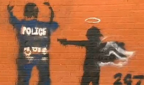 بالصور: غضب الشرطة الأمريكية بسبب "جرافيتي" ملاك يطلق النار على ضابط