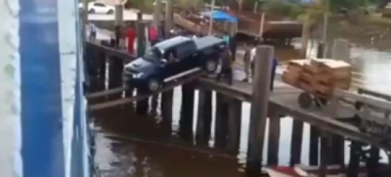 شاهد: متهور يعبر حاجز مائي بسيارته مستخدماً عارضتين خشبيتين