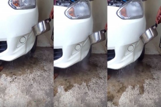 شاهد.. تايلندى يصلح صدام سيارته بالماء المغلي