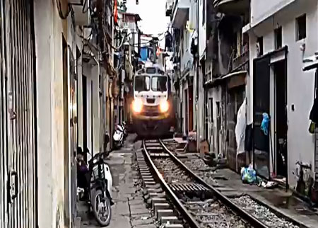 قطار يعبر بين المنازل في فيتنام