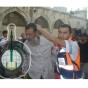 جانب من اقتحامات الاقصى التي وقعت الثلاثاء وشعار الاتحاد العالمي لعلماء المسلمين