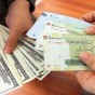 الريال الإيراني والدولار الأميركي