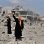 سيدة فلسطينية امام حيها المدمر