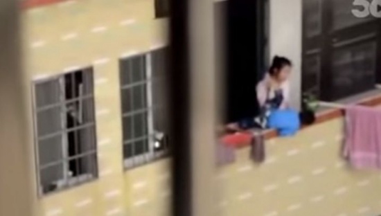 شاهد.. أم تحاول رمي طفلها الصغير من البلكونة بسبب بكائه
