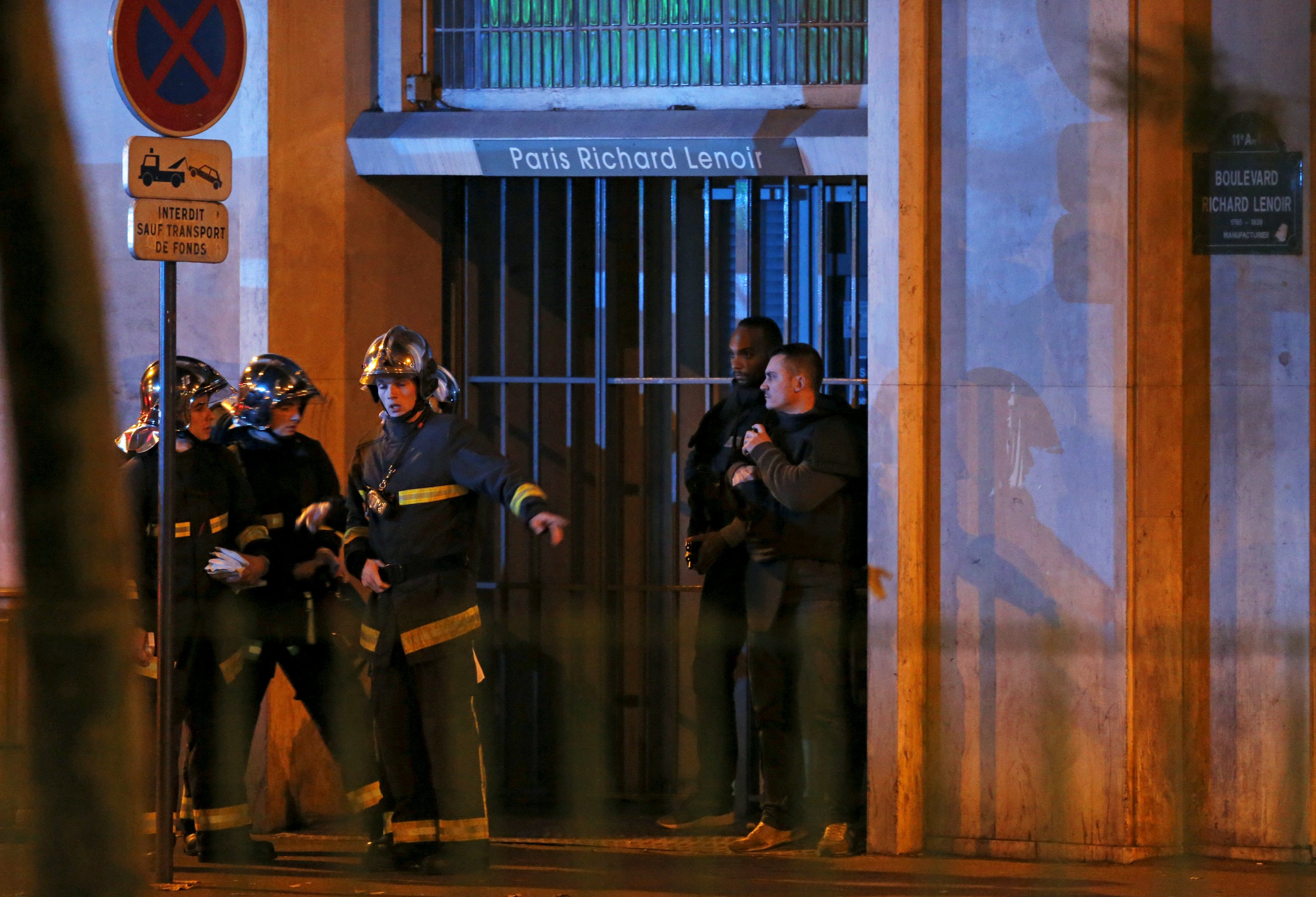 French fire brigade members secure the area near the Bataclan concert hall following fatal shootings in Paris, France, November 13, 2015. At least 30 people were killed in attacks in Paris and a hostage situation was under way at a concert hall in the French capital, French media reported on Friday. REUTERS/Christian Hartmann