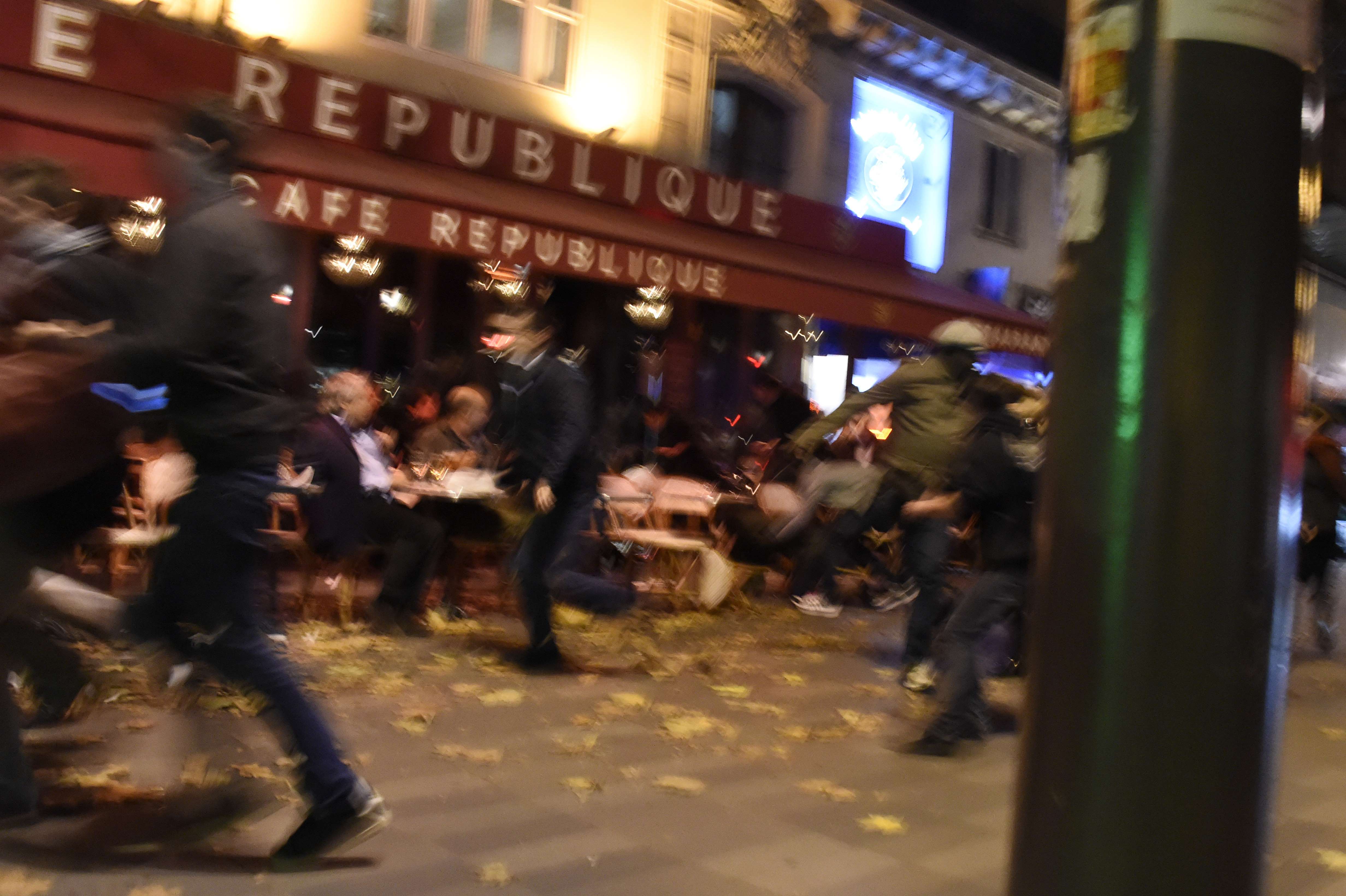People run after hearing what is believed to be explosions or gun shots near Place de la Republique square in Paris on November 13, 2015. At least 18 people were killed in several shootings and explosions in Paris today, police said. AFP PHOTO / DOMINIQUE FAGET