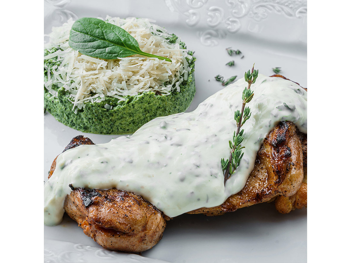 Chicken leg quarter steak with cheese sauce and spinach Order