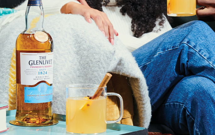 A couple enjoying The Glenlivet Founders and a Hot Toddy Cocktail