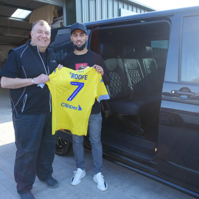 Paul our MD and Kemar Roofe with a signed Leeds United shirt outside his reupholstered VW T6