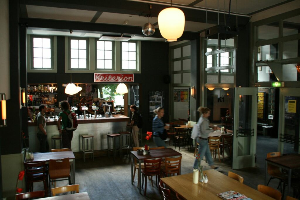 The interior of a bar with some people in it during the day