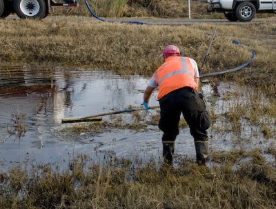 A worker helps clean up an oil spill