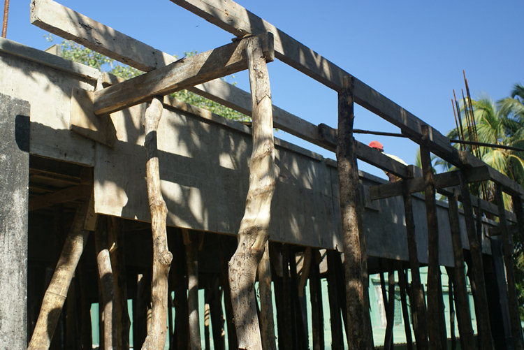 Shuttering is used to make a mould for a reinforced concrete lintal and wood is used for scaffolding in Sri Lanka Shuttering