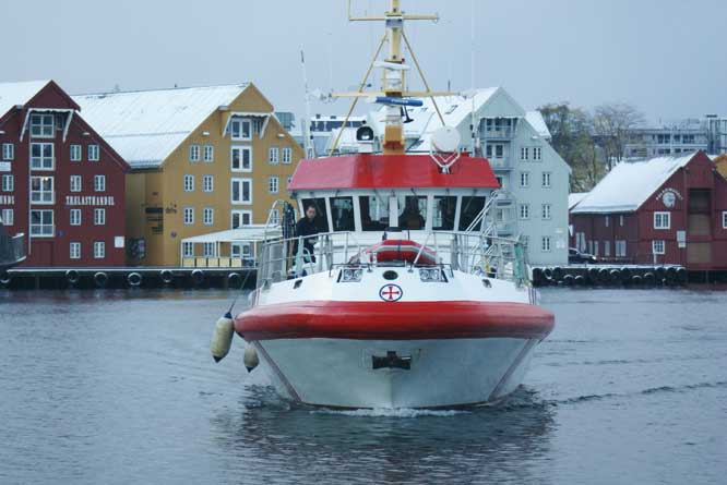 Ship and the old warehouses in tromso harbour Norway