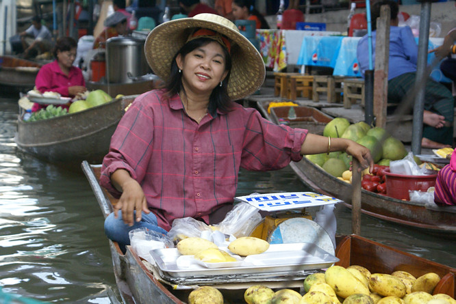 Vegitable seller at the Damnoen Saduak Floating Market Bangkok Day Trip veg and fruit seller