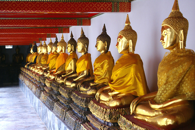 The main Chapel yard is lined with a double cloisters and lines of gold seated Buddha Bangkok gold seated Buddha