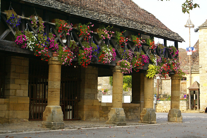 Photo of Domme market hall, the hill top walled city overlooking the Dordogne River Valley in France Domme open air market