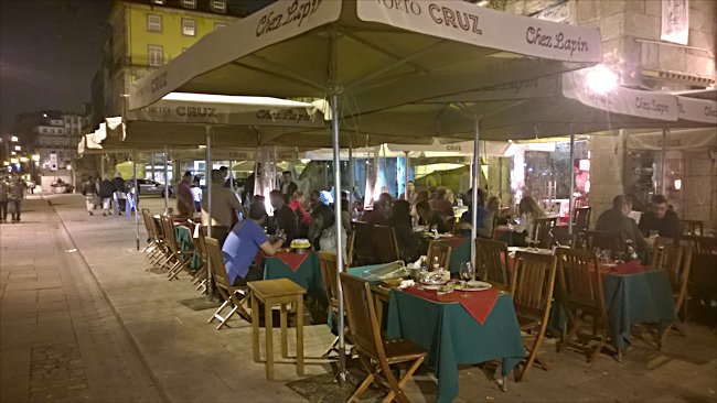 Porto's Cais da Ribeira river front is full of turists day and night The Cais da Ribeira waterfront cafe at night