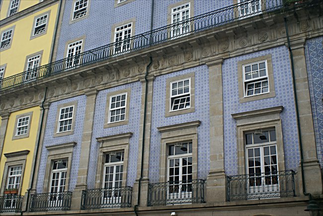 Porto's Ribeira square has some attractive hotels The yellow and blue hotel frontages at Praca da Ribeira plaza