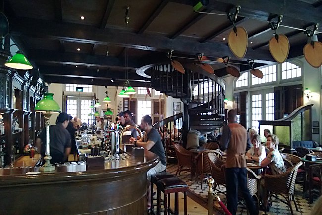 The long bar at Raffles hotel in Singapore where you order the Singapore Sling Cocktail Raffles Hotel Long Bar