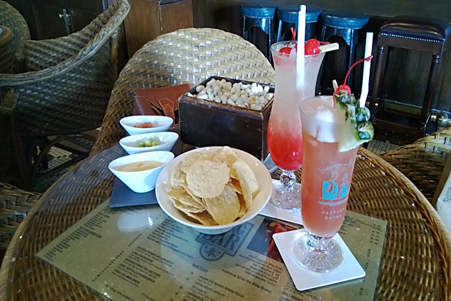 Singapore Sling Cocktail and free monkey nuts at the Long bar in Raffles Hotel Singapore Sling Cocktail