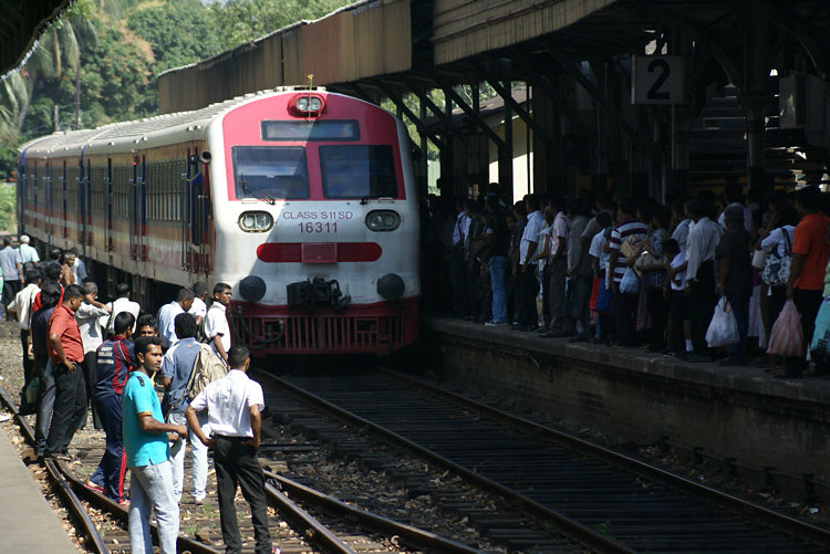 Catching a train from the track side to beat the rush at Colombo Fort Railway Station Colombo Fort Railway Station