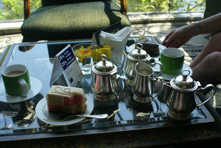 Afternoon tea and cake in the Hilton Hotel Tea Room with water garden view Afternoon tea and cake