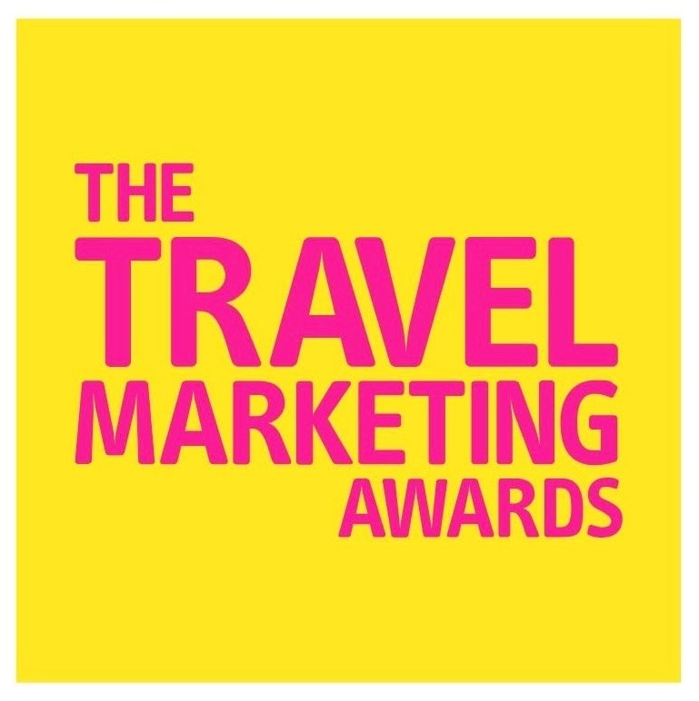 Pink text on a bright yellow background. Text reads: The Travel Marketing Awards.
