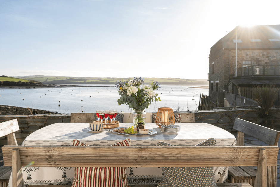 An outdoor dining table with fabulous views over the sea at 2 Quay Cottages..