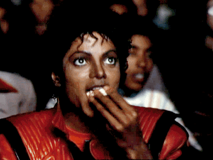 Michael Jackson joyfully eating popcorn.
