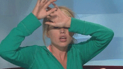 A woman facepalming heavily.