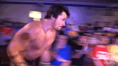 Wrestler jumping into the ring to help out his teammate.