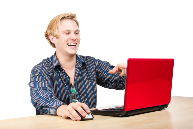 picture web surfer laughing behind laptop