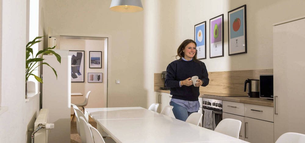 Tessa walking in the new office kitchen.