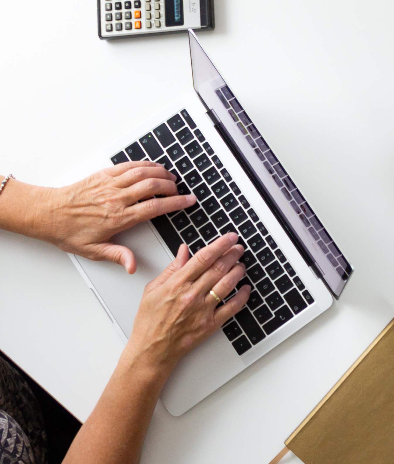 Photo of woman typing on a laptop