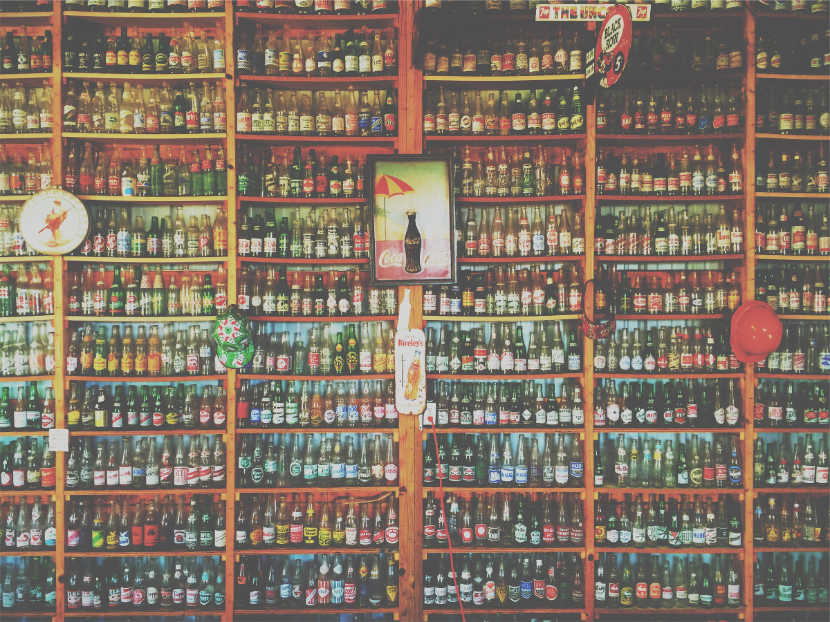 photograph picture of a goods shelf filled with bottled drinks