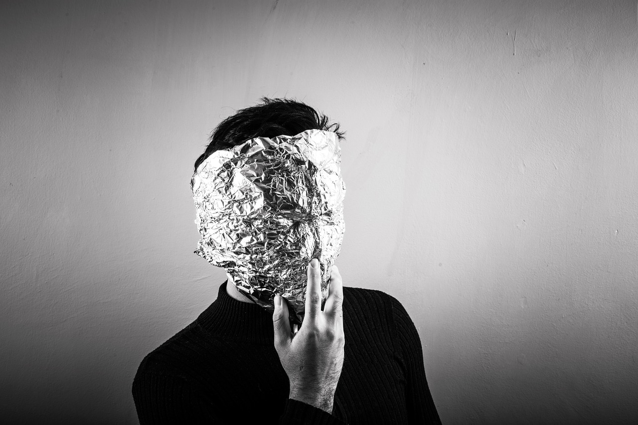 photograph picture of a man covering his face aluminium foliage anonymous