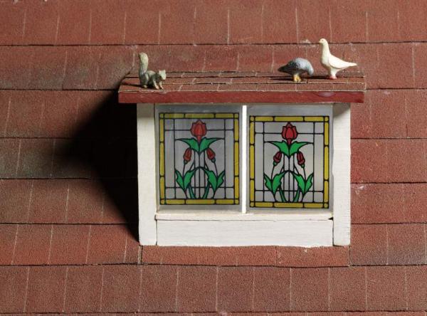 Making sure tiny pigeons and squirrels are securely attached to the roof of the Roma Hopkinson house. © Victoria and Albert Museum, London.