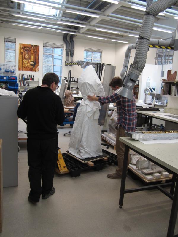 Technicians moving the urn out of the Conservation Studios Technicians moving the urn out of the Conservation Studios