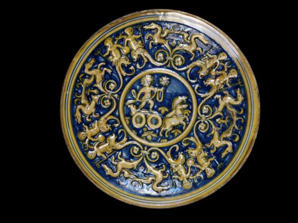 Moulded, tin-glazed earthenware dish with lustre decoration, depicting Apollo driving his chariot