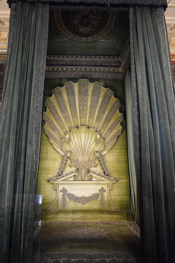 State bed designed by William Kent for Sir Robert Walpole, with hangings of green silk velvet and silver- thread embroidery.