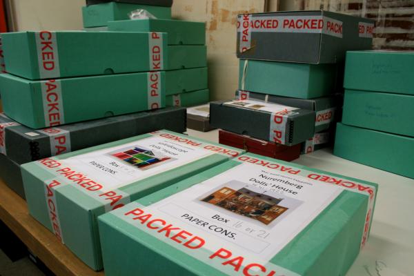 Boxes of dolls house parts waiting to be assessed and repacked for the exhibition. © Victoria and Albert Museum, London.