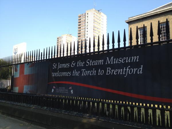 Banner on railings welcoming Olympic torch